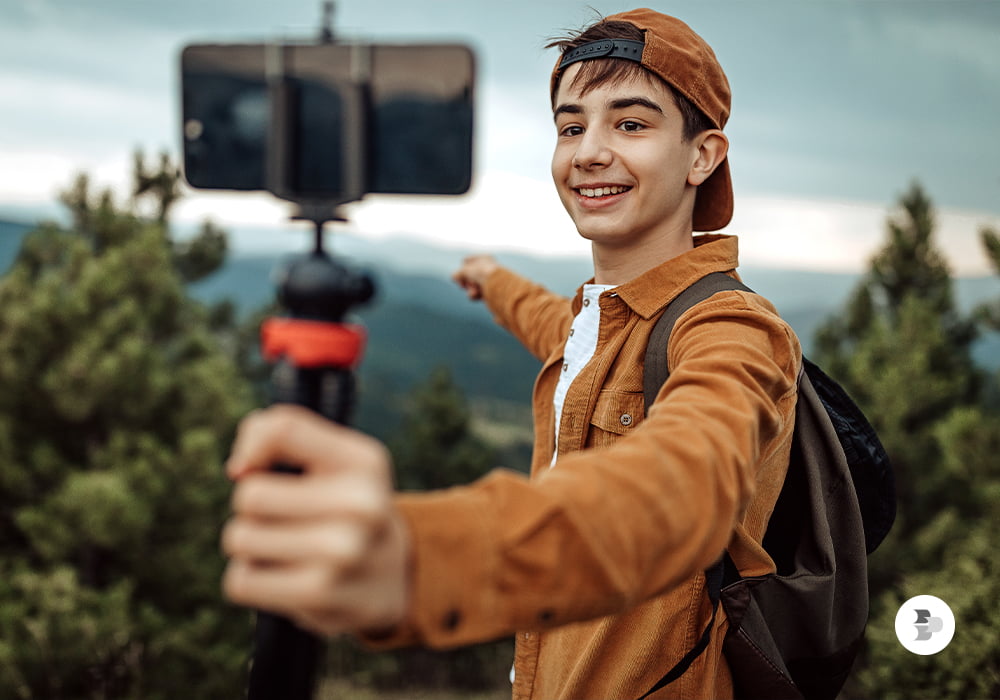 Um jovem tirando uma selfie na natureza. Dicas fotografia.