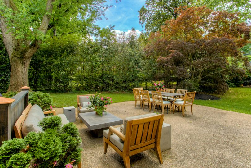 Um jardim com vários móveis em sua decoração. Móveis para jardim.