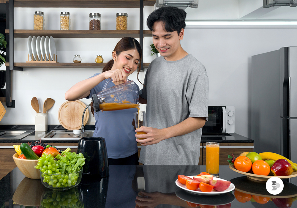 Um casal tomando uma batida de liquidificador em casa. Liquidificador ideal.