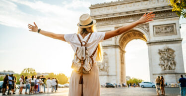 Uma moça conhecendo o Arco do Triunfo em Paris. França.